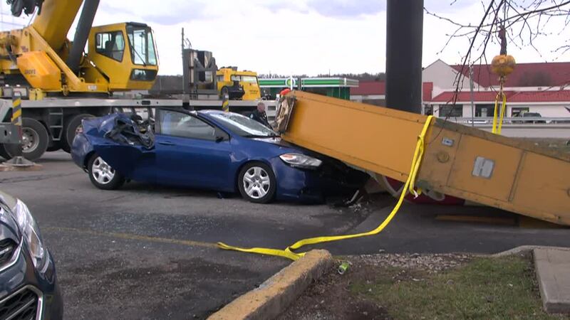 A 72-year-old woman died and two others were injured after a sign fell on a car at a Denny's...